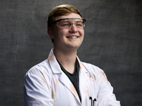 Braden smiling in his lab coat